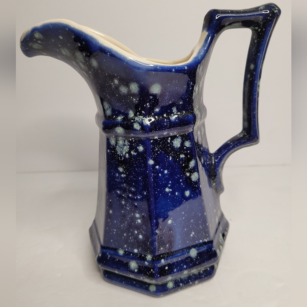 Blue pitcher with among pattern.  274